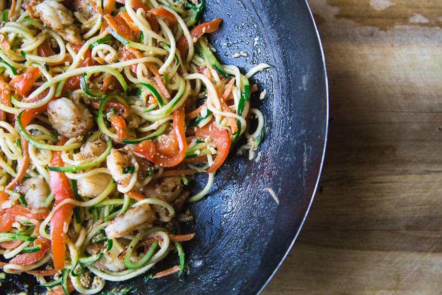 Healthy weight watchers meal with shrimp and zucchini on a dark plate