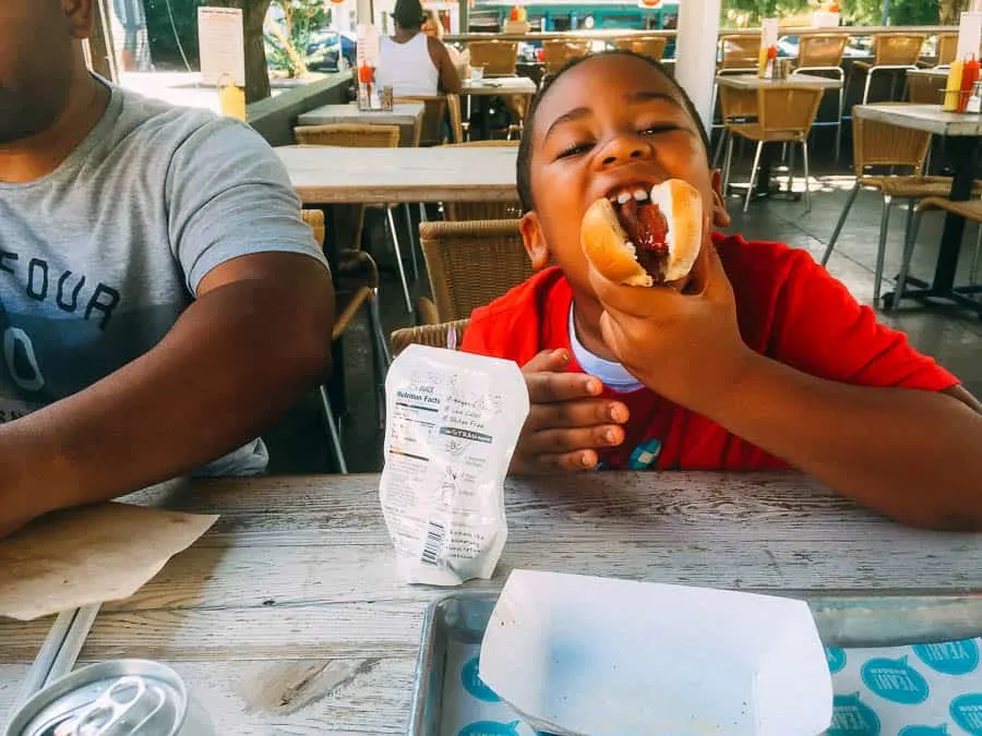 he loved eating his gluten free hotdog.