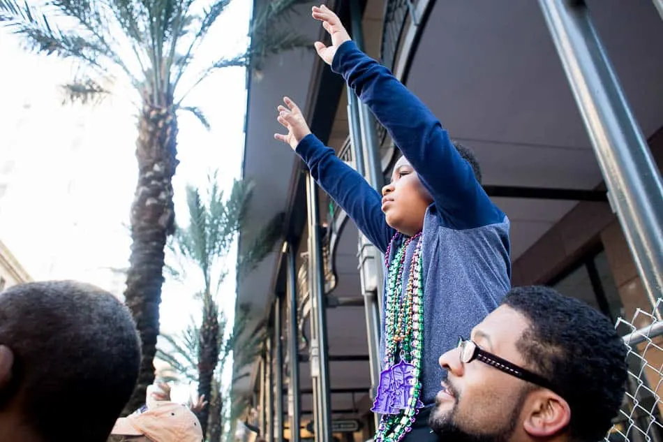 Hands up to catch beads at Mardi Gras