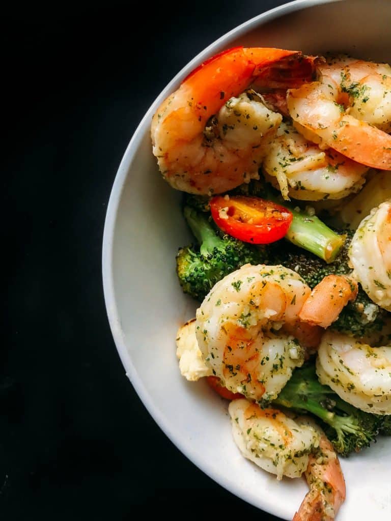 Shrimp, broccoli, tomatoes in a bowl for shrimp scampi. 