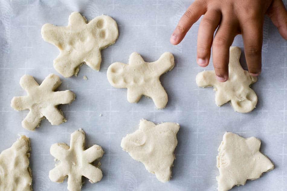 kids hands making christmas gluten free sugar cookies