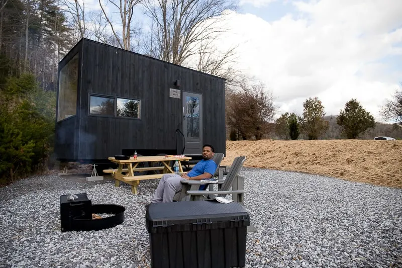 Cdub relaxing in front of a fire at Getaway House Atlanta