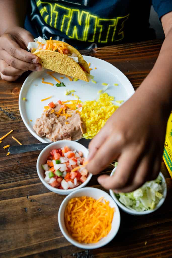 Gluten Free Taco Tuesday with Old el paso. Kid making tacos.