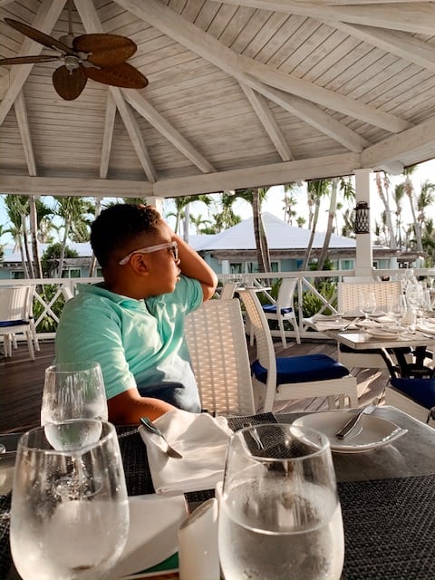 boy watching the sunset at dinner at beaches resort