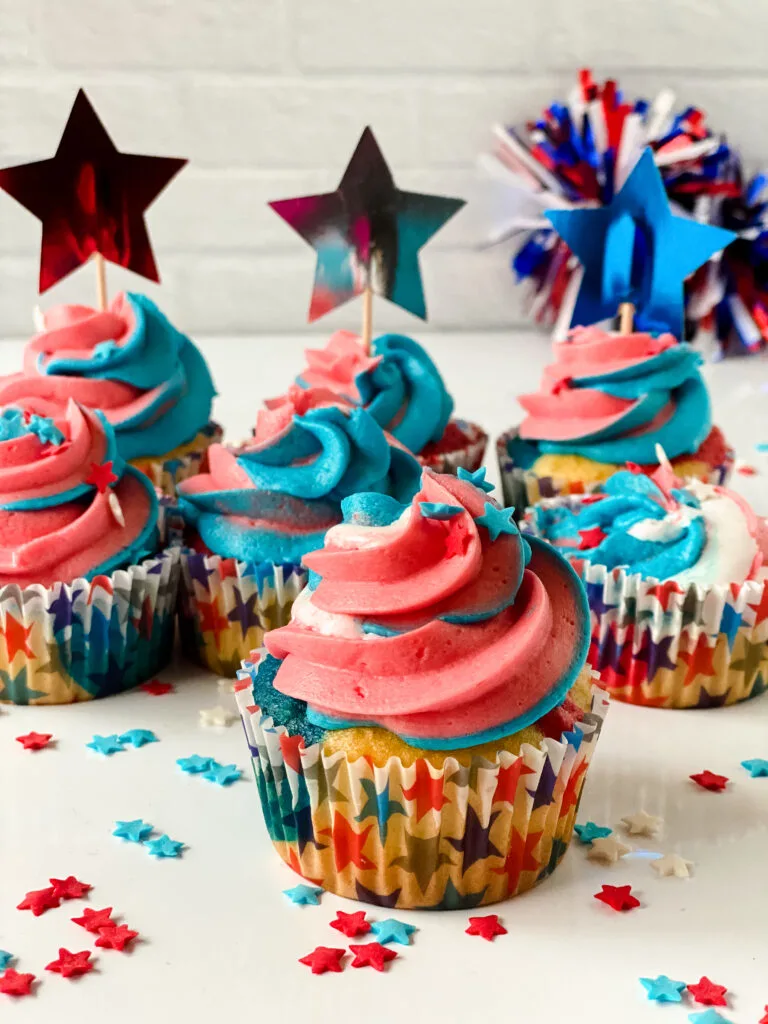 Easy to make red white and blue cupcakes for 4th of July displayed on a table. 