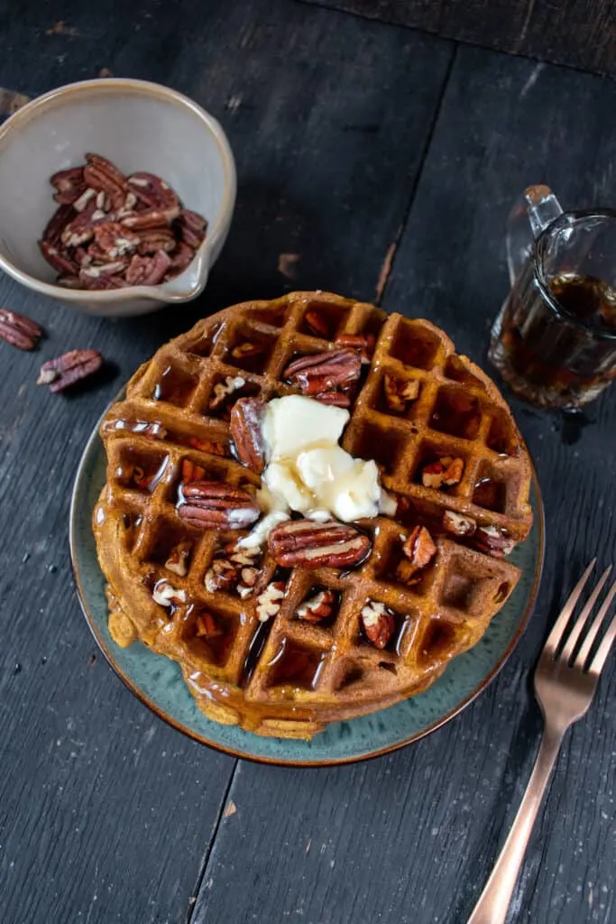 gluten free pumpkin waffle with butter and pecans and syrup