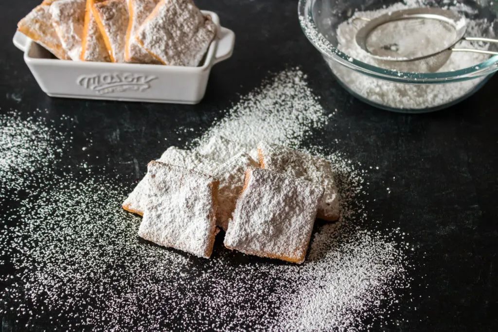 gluten free beignets on a black background