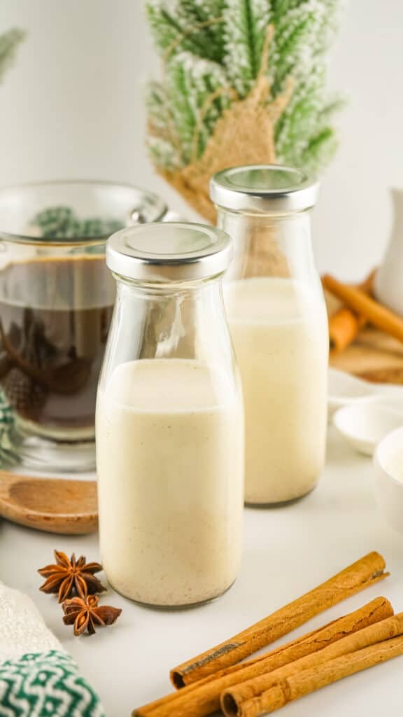 homemade eggnog coffee creamer in milk bottles on a table