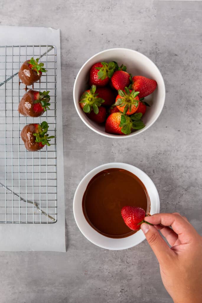 dipping strawberries into the chocolate