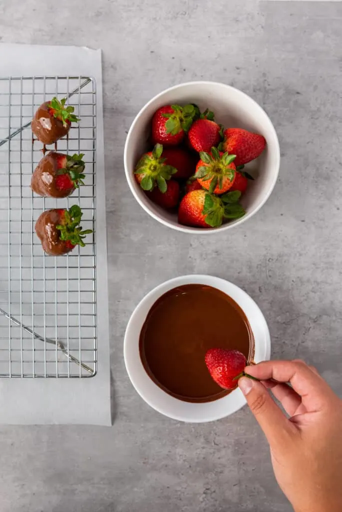 dipping strawberries into the chocolate