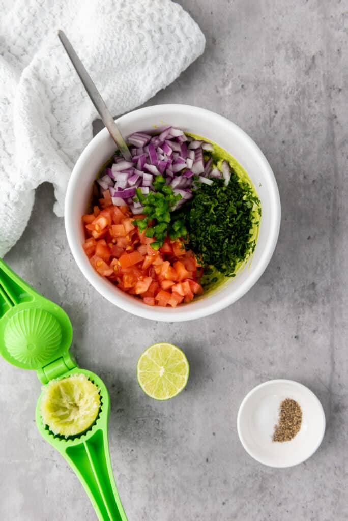 ingredients in a bowl to make gluten free guacamole 
