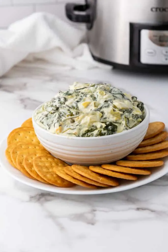 serve the gluten free spinach artichoke dip with crackers, bread or corn chips. 