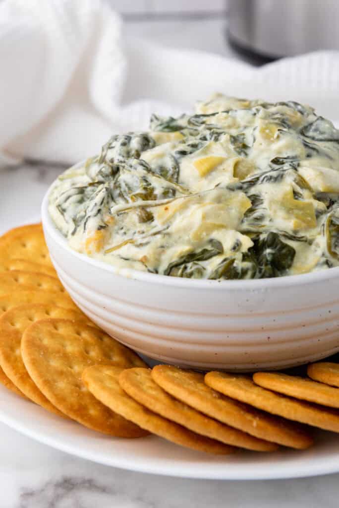 This Gluten Free Artichoke Dip Recipe is the perfect appetizer.Made in the slow cooker, this creamy and cheesy dip is perfect party addition.